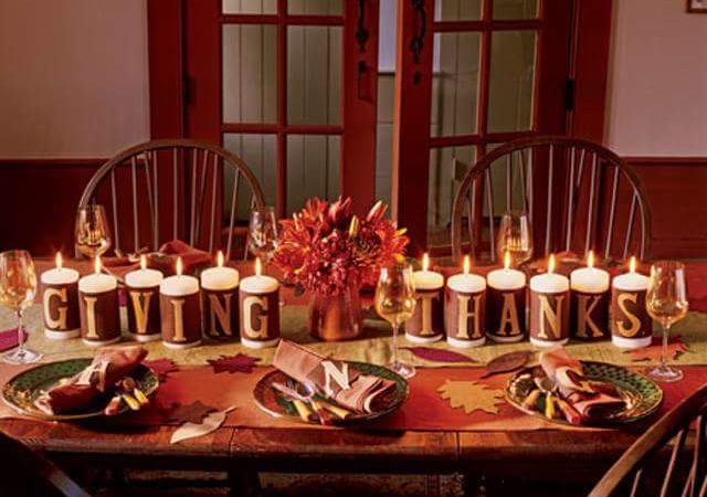 Illuminated Candles On Dining Table